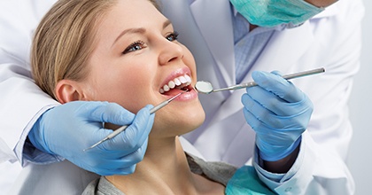 a patient smiling after getting a dental crown
