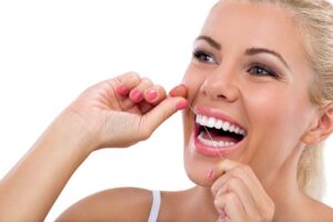 Woman flossing her teeth