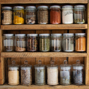 An aesthetically arranged spice cabinet of mason jars